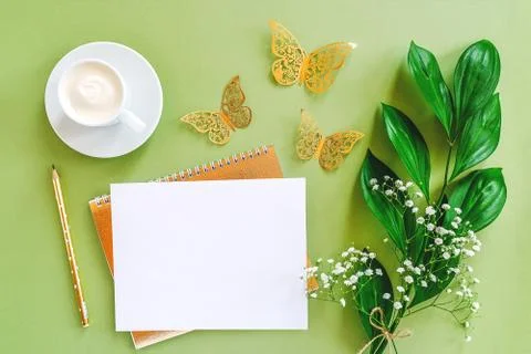 Workspace with blank sheet of notepad, pencil, green leaf, decorative golden  Foto stock