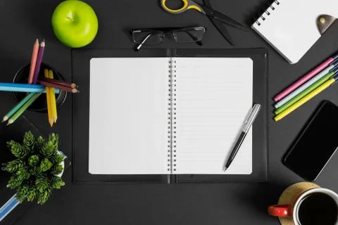 Workspace with book, pen and multiple office supplies. Top View. Stock Photos