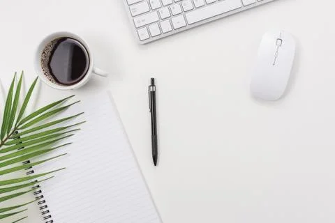Workspace with computer keyboard, green leaf, and coffee cup Stock Photos