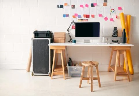Workspace In Creative Studio With Desk And Computer In Front Of Wall With 스톡 사진