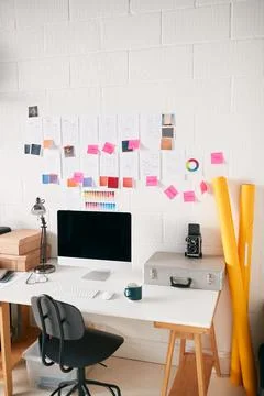 Workspace In Creative Studio With Desk And Computer In Front Of Wall With 스톡 사진