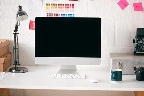 Workspace In Creative Studio With Desk And Computer In Front Of Wall With 스톡 사진