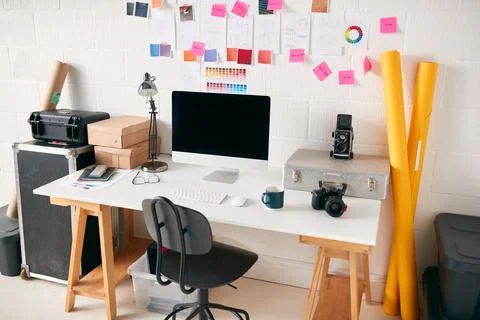Workspace In Creative Studio With Desk And Computer In Front Of Wall With 스톡 사진