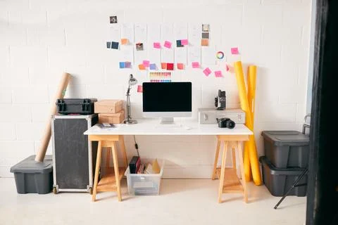 Workspace In Creative Studio With Desk And Computer In Front Of Wall With 스톡 사진