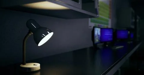 Workspace with desk lamp and computer monitors in low light setting Stock Illustration