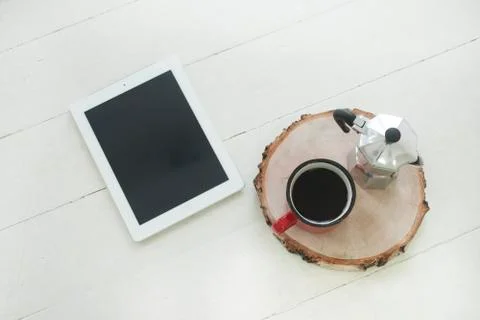 Workspace digital tablet on the table with blank screen on wooden table with cup Stock Photos