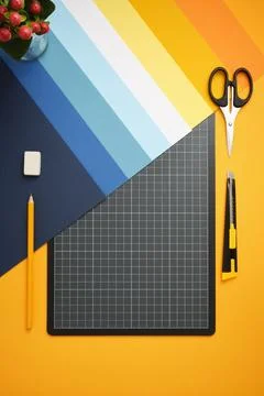 Workspace for DIY projects. Colored paper, cutting mat, pencil, knife, scis.. Stock Photos