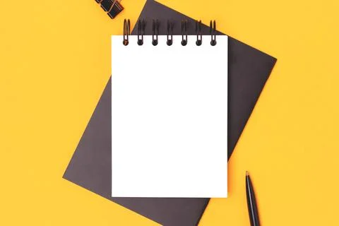 Workspace with empty notepad mock up and black colored stationery. Stock Photos