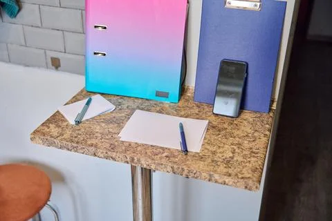 Workspace with gradient binder pen and blank paper on marble table under so.. Stock Photos