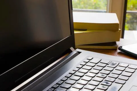 Workspace at home, notebook, mobile device, coffee and plants on the table Stock Photos
