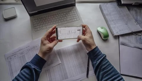 Workspace with a laptop and various documents, suggesting a focus on data Stock Photos
