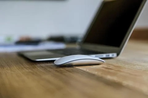Workspace with a laptop and wireless mouse 写真素材