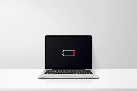 Workspace with laptop computer low battery sign on screen Stock-Illustration