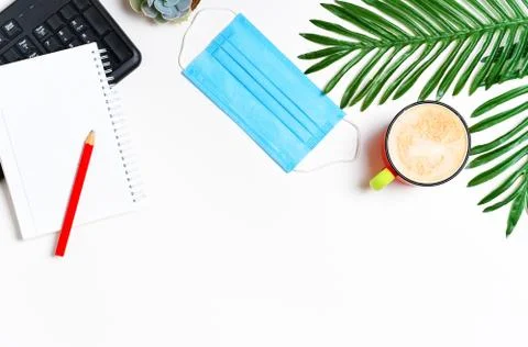 Workspace layout with keyboard, notepad and cappuccino coffee cup Foto stock