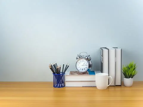 Workspace mock up white table top with Coffee cup, Pencils, Book, Alarm clo.. Stock Photos