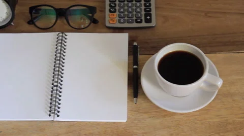 Workspace with notebook, coffee cup and alarm clock in home Stock Footage 63214100