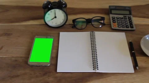 Workspace with notebook, coffee cup and alarm clock in home Vidéo 63214112