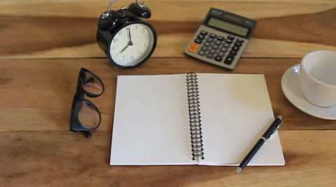 Workspace with notebook, coffee cup and alarm clock in home Stock-Footage 63214118