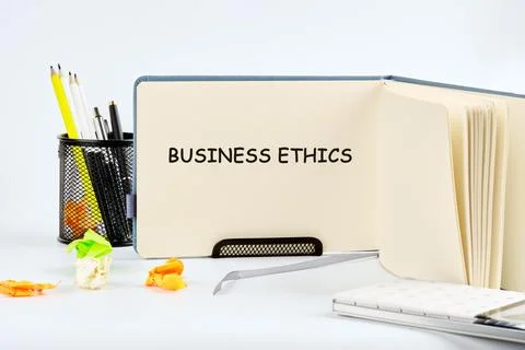A workspace is organized with notes on business ethics, emphasizing essential Stock Photos