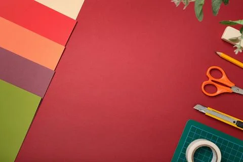 Workspace for paper crafts. Colored sheets, cutting mat, tape, pencil, knife, Stock Photos