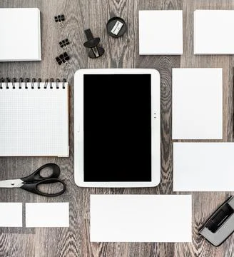 Workspace setup with tablet, notepad, and stationery on wooden desk during Stock Photos