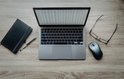 Workspace on the table. Hands typing on a laptop keyboard. Black notebook Stock-Fotos