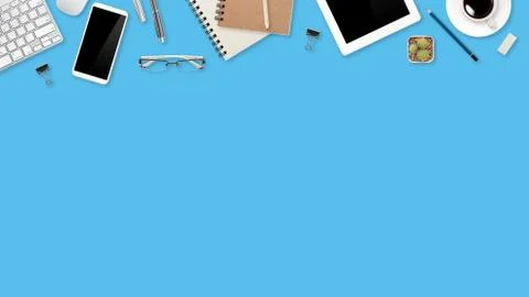 Workspace table with laptop computer, office supplies on blue background Stock Photos