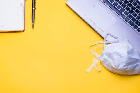 Workspace table with mask and gloves to protect yourself from viruses. Stock Photos