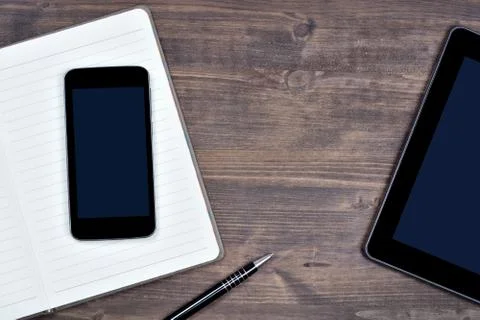 Workspace with telephone, digital tablet, notepad and pen Stock Photos