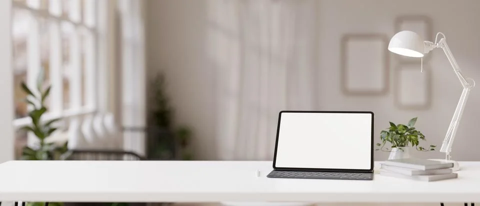 Workspace with a white-screen digital tablet mockup on a white table in a m.. Illustrazione stock