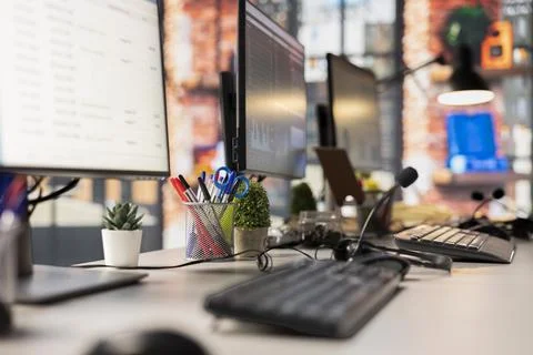 Workstation, computer, empty call center and microphones on desk Stock Photos