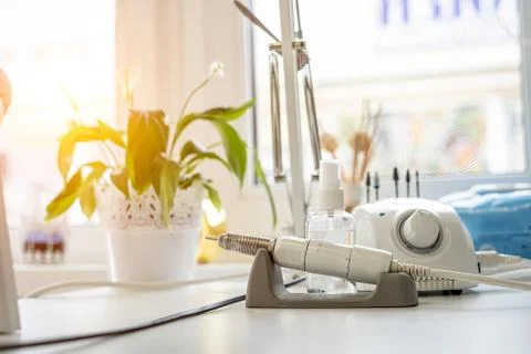 Workstation of the manuyur master. Grinder for processing nails. Stock Photos