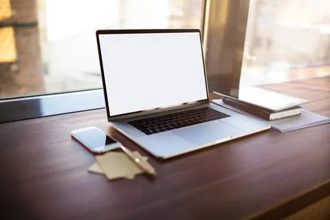 Workstation with open pc laptop computer with blank display background for ad Stock Photos