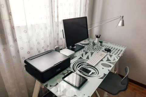 Workstation with table, chair, computer and printer Stock Photos