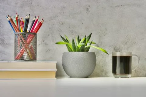 A worktable with two small books, lots of crayons, coffee and copy space Stock Photos