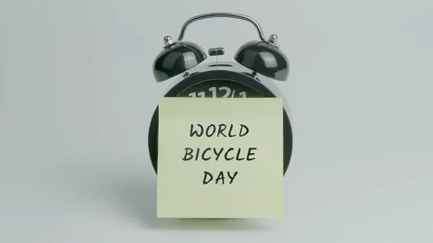 World Bicycle Day Text or Word on Yellow Note Paper Sticking onto Clock Stock Footage 299730620