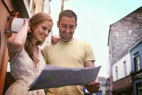 The world is a book with every page worth reading. a happy young couple reading Stock Photos