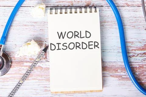 World Disorder text is written on a notebook that lies on old vintage boards Foto stock