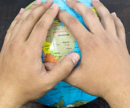 World environment day concept: hands touching globe Stock Photos