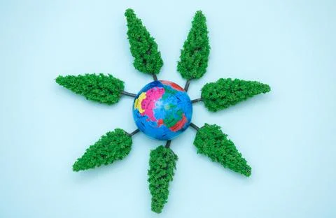 World environment day concept. Layout of planet Earth with green plants. Invest Stock Photos