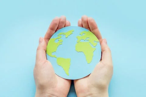 World environment day concept. Two human hands holding paper earth globe is.. Stock Photos