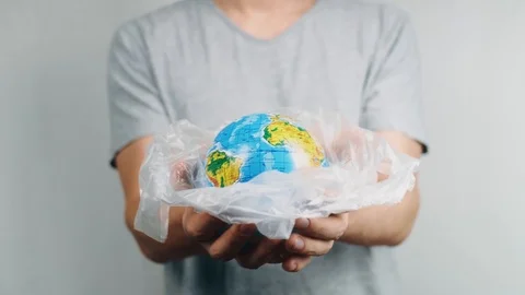 World Environment Day. Man's hands holds the earth in a plastic bag. The glob Stock Footage 121583850