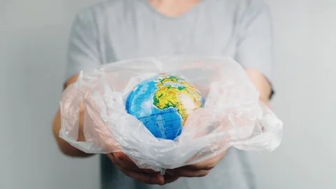 World Environment Day. Man's hands holds the earth in a plastic bag. The glob Stock-Footage 121583854