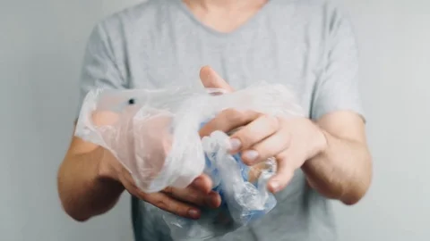 World Environment Day. Man's hands holds the earth in a plastic bag. The glob Stock Footage 121583861