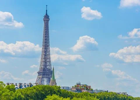 World famous Eiffel tower under a blue sky with clouds Stock Photos