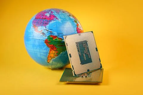 World globe and microprocessors against an orange background Stock-Fotos