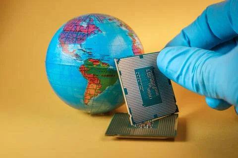 World globe and microprocessors against an orange background Stock Photos