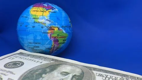 World globe displayed with a U.S. hundred-dollar bill, Stock Photos