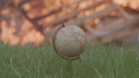 World Globe in Grass in Front of a Large Outdoor Fire 動画素材 208803461