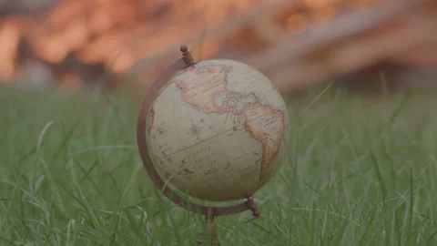 World Globe in Grass in Front of an Outdoor Fire 動画素材 208803696
